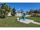 Lawn statue with tropical landscaping, pool building in the background at 88 Bainbridge Dr # 88, Nokomis, FL 34275