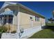 Cozy single-story home featuring light yellow siding and pristine white trim at 88 Bainbridge Dr # 88, Nokomis, FL 34275