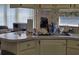 Compact kitchen features a stainless steel sink and abundant natural light at 88 Bainbridge Dr # 88, Nokomis, FL 34275