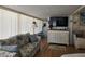 Comfortable living room featuring bright windows and a large-screen television at 88 Bainbridge Dr # 88, Nokomis, FL 34275