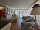Comfortable living area with recliner, sofa, and natural light streaming through windows at 88 Bainbridge Dr # 88, Nokomis, FL 34275