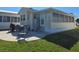 Exterior features a patio, chairs, grill, and landscaping at 88 Bainbridge Dr # 88, Nokomis, FL 34275