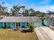 Quaint home featuring a bright exterior, gray roof, and detached garage with ample parking space at 931 Olympia Rd, Venice, FL 34293