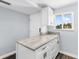 Kitchen island features white cabinets and granite countertops at 995 Laguna Drive # 303, Venice, FL 34285