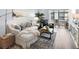 Living room featuring comfortable seating, stylish decor, and bright sunroom at 995 Laguna Drive # 303, Venice, FL 34285