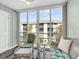 Bright sunroom features lots of light, comfortable seating and neutral paint at 995 Laguna Drive # 303, Venice, FL 34285