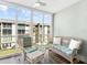 Bright sunroom with comfortable seating and large windows to enjoy the beautiful views at 995 Laguna Drive # 303, Venice, FL 34285