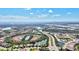 An aerial view of the community, showing how it's located near a community lake and roadways at 351 Carlino Dr, Nokomis, FL 34275