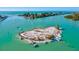 Scenic aerial view of boats near a sandy island and turquoise water at 351 Carlino Dr, Nokomis, FL 34275