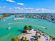 Breathtaking aerial view of a coastal community, with boats, turquoise waters, sandy beaches, and ample parking at 351 Carlino Dr, Nokomis, FL 34275