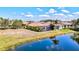 An aerial view of a residence situated alongside a tranquil pond at 351 Carlino Dr, Nokomis, FL 34275