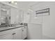Modern bathroom featuring tiled walls, a seamless glass shower, and granite countertops at 351 Carlino Dr, Nokomis, FL 34275