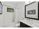Bright bathroom featuring a marble countertop, a tub, and large mirror at 351 Carlino Dr, Nokomis, FL 34275