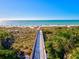 Picturesque beach boardwalk leading to a sunny beach with blue ocean views at 351 Carlino Dr, Nokomis, FL 34275