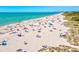 Scenic beach view with clear blue water, sandy shores dotted with beachgoers, providing an idyllic coastal retreat at 351 Carlino Dr, Nokomis, FL 34275