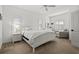 Bright and airy bedroom with plantation shutters, neutral carpeting, and a comfy chair at 351 Carlino Dr, Nokomis, FL 34275