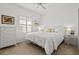 Well-lit bedroom with a white comforter, white dresser and natural light from shuttered windows at 351 Carlino Dr, Nokomis, FL 34275