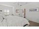 Bright bedroom featuring a ceiling fan, window with shutters, and ensuite bathroom entrance at 351 Carlino Dr, Nokomis, FL 34275