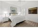Well-lit bedroom featuring neutral tones, side tables and a large shuttered window at 351 Carlino Dr, Nokomis, FL 34275