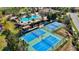 Aerial view of the community center with a pool, pickleball courts, and plenty of parking at 351 Carlino Dr, Nokomis, FL 34275