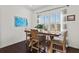 Cozy dining room with plantation shutters, hardwood floors, and bright artwork at 351 Carlino Dr, Nokomis, FL 34275