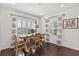 Dining room featuring hardwood floors, plantation shutters, and a decorative light fixture at 351 Carlino Dr, Nokomis, FL 34275