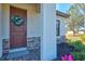 Charming entryway featuring a decorative wreath and stone accents at 351 Carlino Dr, Nokomis, FL 34275