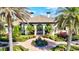 Stunning home exterior with arched entryways, lush landscaping, and a decorative fountain at 351 Carlino Dr, Nokomis, FL 34275