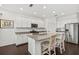 White kitchen with granite countertops, stainless appliances and large island at 351 Carlino Dr, Nokomis, FL 34275