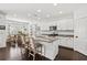Bright kitchen with white cabinets, granite countertops, stainless steel appliances, and an island with seating at 351 Carlino Dr, Nokomis, FL 34275