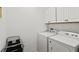 A white laundry room featuring a washer and dryer with cabinet storage at 351 Carlino Dr, Nokomis, FL 34275