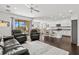 Open-concept living room with access to the kitchen and views of the pool area at 351 Carlino Dr, Nokomis, FL 34275