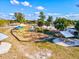 Picturesque park playground with swings, slides, and picnic areas, surrounded by trees on a bright, sunny day at 351 Carlino Dr, Nokomis, FL 34275