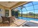 Covered patio featuring a screened-in pool with a picturesque water view at 351 Carlino Dr, Nokomis, FL 34275