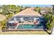 Screened in pool with outdoor kitchen and patio furniture to enjoy those summer days at 351 Carlino Dr, Nokomis, FL 34275