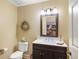 Stylish half bathroom featuring a modern vanity, wall mirror, white fixtures, and neutral wall color at 100 Central Ave # D509, Sarasota, FL 34236