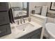 Bathroom vanity and mirror with stone countertop, decorative accents and a towel rack at 100 Central Ave # D509, Sarasota, FL 34236