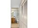 View of a bathroom through a doorway, featuring wood vanity, white toilet, and closet at 100 Central Ave # D509, Sarasota, FL 34236