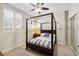 Bedroom featuring a four-poster bed, and shuttered windows at 100 Central Ave # D509, Sarasota, FL 34236