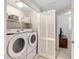 Bright laundry room featuring a washer, dryer, and storage shelves at 100 Central Ave # D509, Sarasota, FL 34236