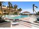 Upscale condominium pool with lounge chairs and mature palm trees at 100 Central Ave # D509, Sarasota, FL 34236