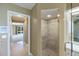 Bathroom featuring tiled walk-in shower, and adjoining access to an additional room at 1358 Ewing St, Nokomis, FL 34275