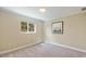 Cozy bedroom with neutral walls, soft carpeting, and a sunlit window at 1358 Ewing St, Nokomis, FL 34275