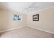 Inviting bedroom featuring neutral walls, soft carpeting, and a sunlit window at 1358 Ewing St, Nokomis, FL 34275