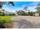 Charming home featuring a long gravel driveway and lush landscaping, providing a serene and private setting at 1358 Ewing St, Nokomis, FL 34275