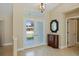 Bright foyer with tiled flooring and a transom window over the glass double doors, creating a welcoming entrance at 1358 Ewing St, Nokomis, FL 34275