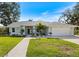 Inviting single-story home with a well-manicured lawn and charming landscaping, creating an attractive and welcoming facade at 1358 Ewing St, Nokomis, FL 34275