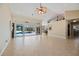 Spacious living room features tile floors, ceiling fan and sliding glass doors leading to a pool at 1358 Ewing St, Nokomis, FL 34275