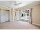 Spacious bedroom featuring a sliding glass door to a screened in patio, closet, and ceiling fan at 1358 Ewing St, Nokomis, FL 34275