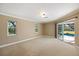 Spacious carpeted main bedroom with two windows and sliding glass door access to pool area at 1358 Ewing St, Nokomis, FL 34275